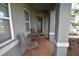 Cozy front porch with seating, offering a welcoming entrance to the home at 709 Calabria Way, Howey In The Hills, FL 34737