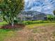 Lush backyard featuring screened-in patio and tropical landscaping at 718 Lake Douglas Dr, Groveland, FL 34736