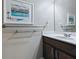 Neutral bathroom with dark wood cabinets and hardware featuring a framed piece of art at 718 Lake Douglas Dr, Groveland, FL 34736