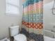 A bathroom features a toilet, a bathtub, and a window with natural light at 718 Lake Douglas Dr, Groveland, FL 34736