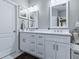 Beautiful bathroom featuring a double sink vanity with white cabinets and modern fixtures at 718 Lake Douglas Dr, Groveland, FL 34736