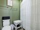 Bathroom featuring a toilet, wicker stool, and a shower/tub combo with white shower curtain at 718 Lake Douglas Dr, Groveland, FL 34736
