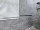 Modern bathroom showcasing a sleek glass-enclosed shower with gray tiling at 718 Lake Douglas Dr, Groveland, FL 34736