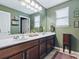 Spacious bathroom featuring double vanity, dark wood cabinets, and decorative wall art at 718 Lake Douglas Dr, Groveland, FL 34736