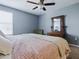 Comfortable bedroom featuring a ceiling fan and antique dresser with mirror at 718 Lake Douglas Dr, Groveland, FL 34736