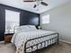 Well-lit bedroom with iron frame bed, carpeting, a ceiling fan, and a neutral palette at 718 Lake Douglas Dr, Groveland, FL 34736