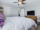 Bedroom features a dresser with mounted TV and natural light from the window at 718 Lake Douglas Dr, Groveland, FL 34736