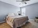 Bedroom featuring carpeting, a ceiling fan, and a queen bed with comforter and decorative pillows at 718 Lake Douglas Dr, Groveland, FL 34736