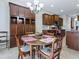 Cozy dining area with a round wooden table and ample storage cabinets in a well-lit open space at 718 Lake Douglas Dr, Groveland, FL 34736