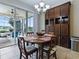 Inviting dining area featuring a wooden table next to sliding glass doors leading to a screened patio at 718 Lake Douglas Dr, Groveland, FL 34736