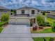 Beautiful two-story home with three-car garage and well-manicured lawn at 718 Lake Douglas Dr, Groveland, FL 34736
