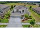 Beautiful two-story home with three-car garage and well-manicured landscaping at 718 Lake Douglas Dr, Groveland, FL 34736