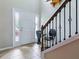 Bright foyer with a tiled floor, a staircase, and a view of the front door with sidelights at 718 Lake Douglas Dr, Groveland, FL 34736