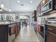 Well-equipped kitchen with granite countertops, tiled backsplash, stainless appliances and view to breakfast nook at 718 Lake Douglas Dr, Groveland, FL 34736