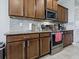 Kitchen featuring stainless steel oven and microwave and beautiful wood cabinetry at 718 Lake Douglas Dr, Groveland, FL 34736