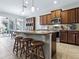 Spacious kitchen featuring granite countertops, stainless steel appliances, and large island with breakfast bar at 718 Lake Douglas Dr, Groveland, FL 34736