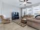 Comfortable living room with a large sectional sofa, recliner, ceiling fan, and large windows for natural light at 718 Lake Douglas Dr, Groveland, FL 34736