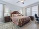 Spacious main bedroom featuring a four-poster bed, wooden furniture, and ample natural light at 718 Lake Douglas Dr, Groveland, FL 34736