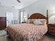 Elegant main bedroom with a large bed, stylish decor, and a view into the bathroom at 718 Lake Douglas Dr, Groveland, FL 34736