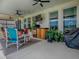 Relax on the covered patio with ample seating, an outdoor kitchen, and beautiful views of the backyard at 718 Lake Douglas Dr, Groveland, FL 34736