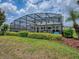 Relaxing screened-in pool area with manicured landscaping at 718 Lake Douglas Dr, Groveland, FL 34736