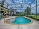 Inviting screened-in pool with easy access steps, surrounded by a spacious patio and well-kept landscaping at 718 Lake Douglas Dr, Groveland, FL 34736