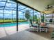 Relaxing screened-in lanai featuring a private pool and comfortable seating area overlooking the lush backyard at 718 Lake Douglas Dr, Groveland, FL 34736