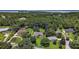 Aerial view of wooded property with house outlined in blue at 7249 Chesterhill Cir, Mount Dora, FL 32757