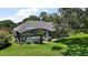 Backyard featuring a screened-in pool and lush green lawn, perfect for relaxation and entertainment at 7249 Chesterhill Cir, Mount Dora, FL 32757