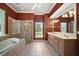 Bathroom with tub, glass shower, and double vanity at 7249 Chesterhill Cir, Mount Dora, FL 32757