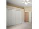 Light-filled bedroom featuring a large closet with bifold doors and an ensuite bathroom at 7249 Chesterhill Cir, Mount Dora, FL 32757