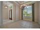 Dining room with a large window offering backyard views and a decorative chandelier at 7249 Chesterhill Cir, Mount Dora, FL 32757