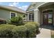 Well manicured landscape with mature bushes and trees frames a double front door entry at 7249 Chesterhill Cir, Mount Dora, FL 32757