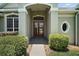 The home features a beautiful double front door with an elegant front porch entry at 7249 Chesterhill Cir, Mount Dora, FL 32757