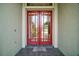 Close up of the front double door entry, with a doormat that says 'Home Sweet Home' at 7249 Chesterhill Cir, Mount Dora, FL 32757