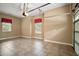 Tiled garage space with window and ceiling fan at 7249 Chesterhill Cir, Mount Dora, FL 32757