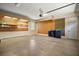 Spacious garage featuring pegboard walls, storage shelving, and overhead lighting at 7249 Chesterhill Cir, Mount Dora, FL 32757