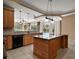 Open kitchen with a large island and views into the living room and pool at 7249 Chesterhill Cir, Mount Dora, FL 32757