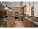 Spacious kitchen features granite countertops, stainless steel appliances, and ample cabinet space at 7249 Chesterhill Cir, Mount Dora, FL 32757