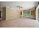 Large living room with built-in shelves and a view of the backyard at 7249 Chesterhill Cir, Mount Dora, FL 32757