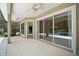 Covered patio with ceiling fans, and sliding glass doors leading to the outdoor pool at 7249 Chesterhill Cir, Mount Dora, FL 32757
