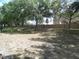 Backyard with lawn, wall, and mature trees at 739 Cortez Ave, The Villages, FL 32159