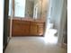 Well-lit bathroom featuring wallpaper, double vanity, and tile flooring at 739 Cortez Ave, The Villages, FL 32159