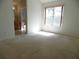 Bright bedroom with large window and carpet flooring with en suite bathroom at 739 Cortez Ave, The Villages, FL 32159