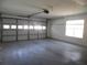 Spacious garage featuring a large overhead door with window panels and lots of natural light at 739 Cortez Ave, The Villages, FL 32159