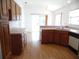Cozy kitchen featuring wood cabinets, laminate countertops, and wood-look laminate flooring at 739 Cortez Ave, The Villages, FL 32159