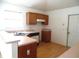 Functional kitchen with wood cabinets, linoleum flooring, and essential appliances at 739 Cortez Ave, The Villages, FL 32159