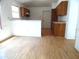 Bright kitchenette with wood cabinets, a partial wall, and linoleum flooring at 739 Cortez Ave, The Villages, FL 32159