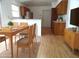 Eat-in kitchen with light countertops, wooden cabinets, stainless refrigerator, and adjacent dining room at 739 Cortez Ave, The Villages, FL 32159