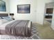 The main bedroom offers a spacious layout with cool gray and white decor, and an ensuite bath access at 739 Cortez Ave, The Villages, FL 32159